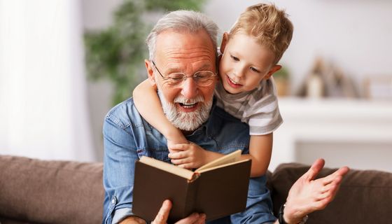 Opa, liest seinem Enkel etwas vor.